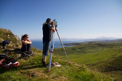 Two researchers surveying a landscape on the Ardnamurchan Peninsula
