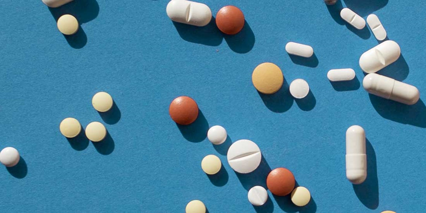 top view of various pills on blue background