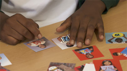 a young child counting using the everybody counts cards on a table