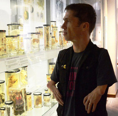 Mat Fraser looking at specimen jars