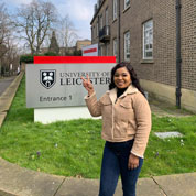 Abigail Chinecherem Ezeikpe standing in front of a University of Leicester sign on campus
