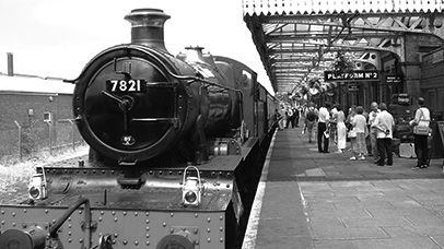 A photo of a steam engine in a train station