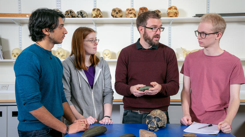 lecturer talking to students about fossils in a classroom