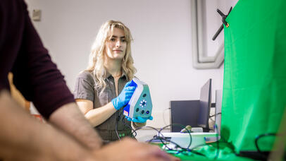 Student holding a hand-held scanner