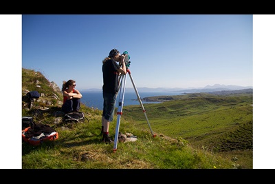 Two researchers surveying a landscape on the Ardnamurchan Peninsula