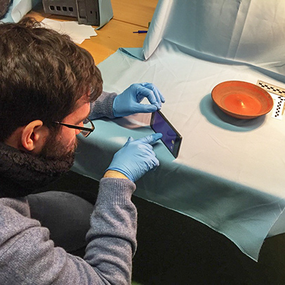 Man taking image of pottery