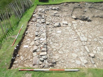 Southern end of trench showing southern wall, internal floor, shallow drain and possible western extension and external cobble surface