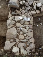 Trench 2 fireplace with reddened stones to south