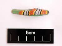 A decorated glass bead shown to be 5cm long