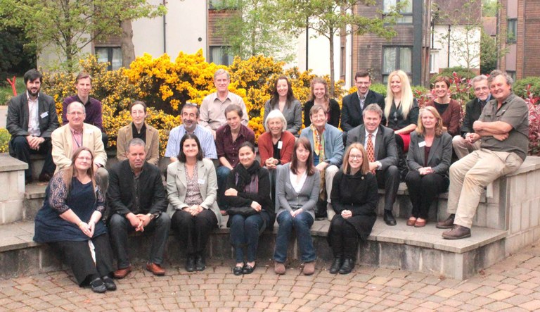 Attendees at the conference seated on stone benches outdoors