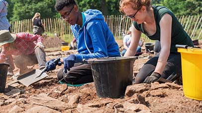 students digging together outside