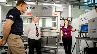 UK astronaut Major Tim Peake being shown the Space Park laboratory equipment by Dr Rebecca Cordell