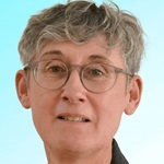 Photograph of Julea Butt against a light blue background.