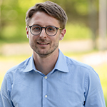 Photograph of Johannes Rebelein, wearing a blue shirt.
