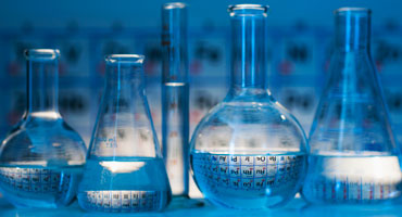 Beakers of various sizes on a table.