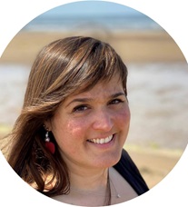 Photograph portrait of Patricia Rodriguez-Macia, standing on a beach.