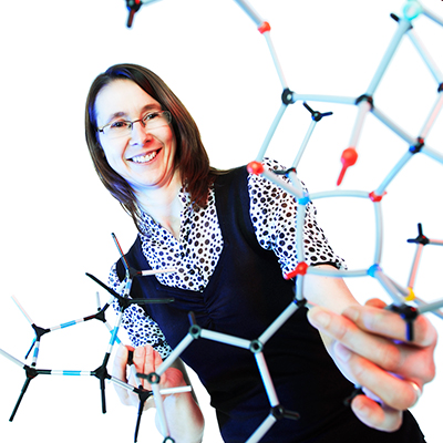 Photograph of Alison Stuart holding a molecular model