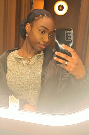 student taking a selfie in a mirror with glowing edges.