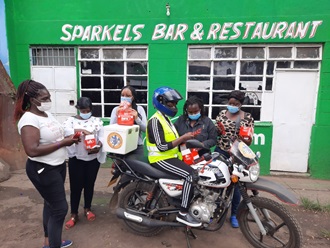 Women stood around a motor bike 