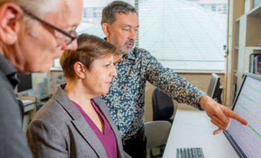 Lisa Smith and two Men in a lab looking at a computer screen