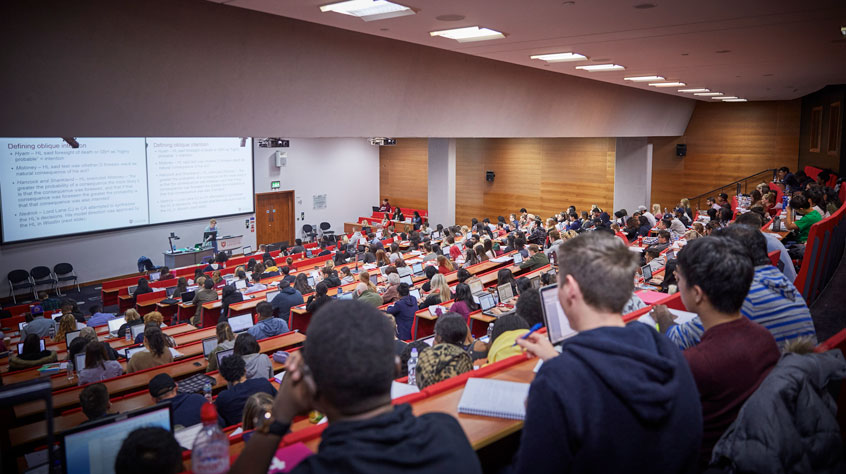 Students sitting in a busy lecture theatre