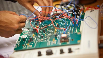 student working on a circuit board