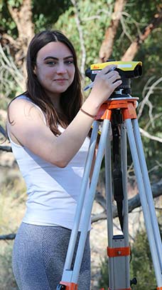 Female using surveying equipment