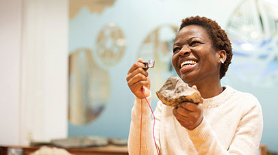A student inspecting a fossil with a magnifying glass