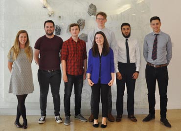 aggregate industries bursary presentation 2018. six students stand in the bennett building foyer with a female representative from aggregate industries.