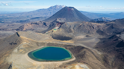 blue lake in front of the mountains tongariro, ngauruhoe, ruapehu in tongariro national park, new zealand