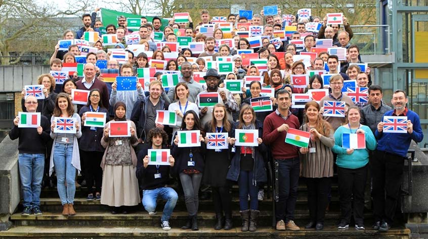 all staff from the Department of Genetics and Genome Biology holding flags