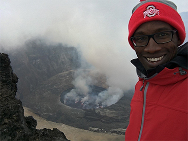 professor christopher jackson with nyiragongo (volcano) behind