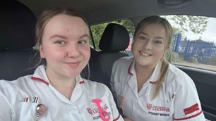 Two midwifery students posing for a picture in a car.