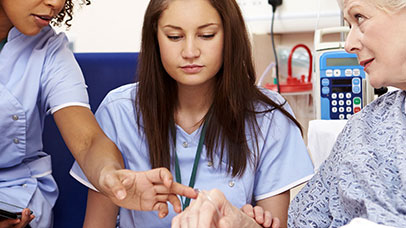 nurses talking to patient