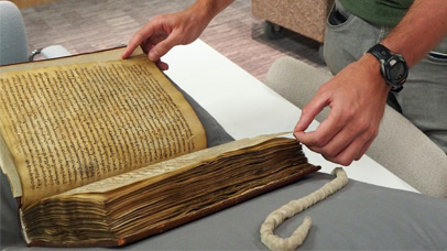 University of Leicester student examining medieval manuscript