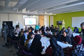 School students sat in groups taking part in an activity School students sat in groups taking part in an activity