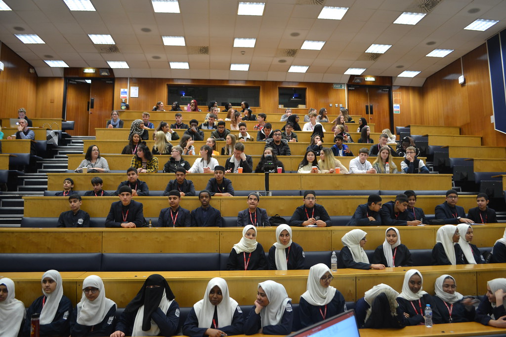 Students sitting in a tiered lecture theatre