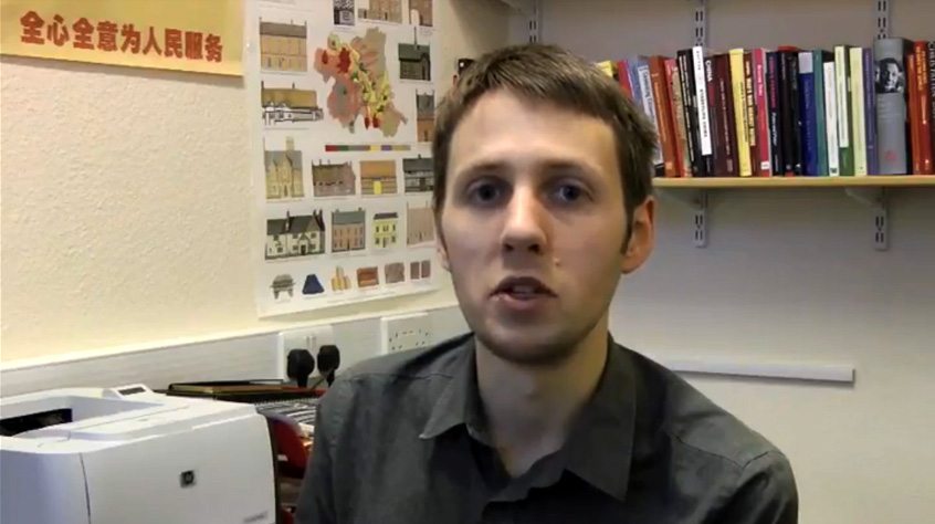video still of man speaking to camera