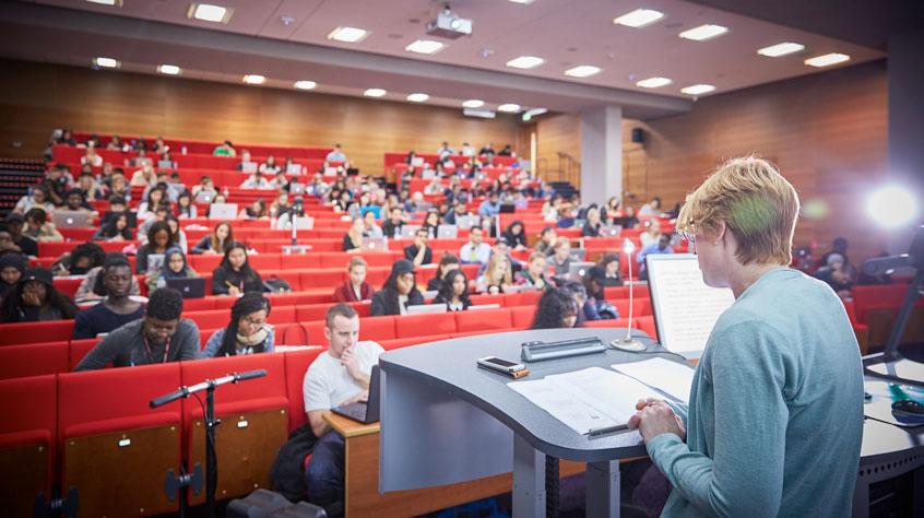 Multiple students sitting in a lecture theatre on Leicester campus.