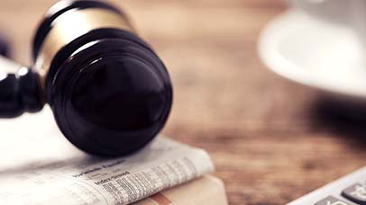 judges gavel sat on a newspaper