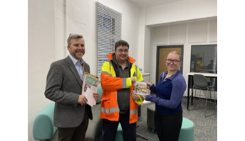 Edward Jones and Ellie Lambert handing over funds for a local flood-prone town