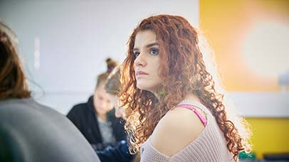 female student listening in class