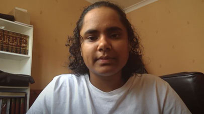 Alumni Faeeza looking into the camera