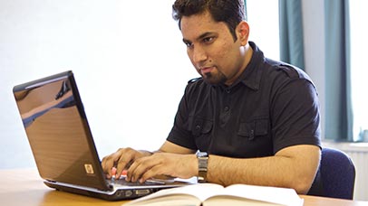 older student using laptop to study