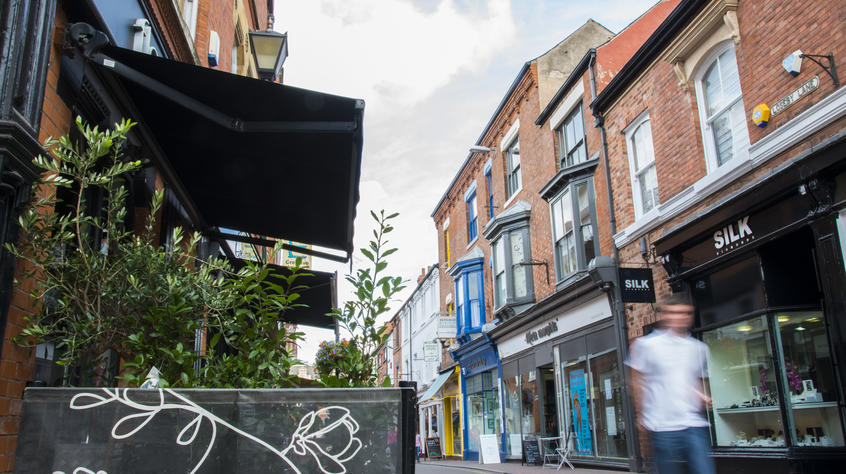 A man walking down a busy high street.