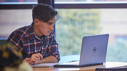Student studying with a laptop computer