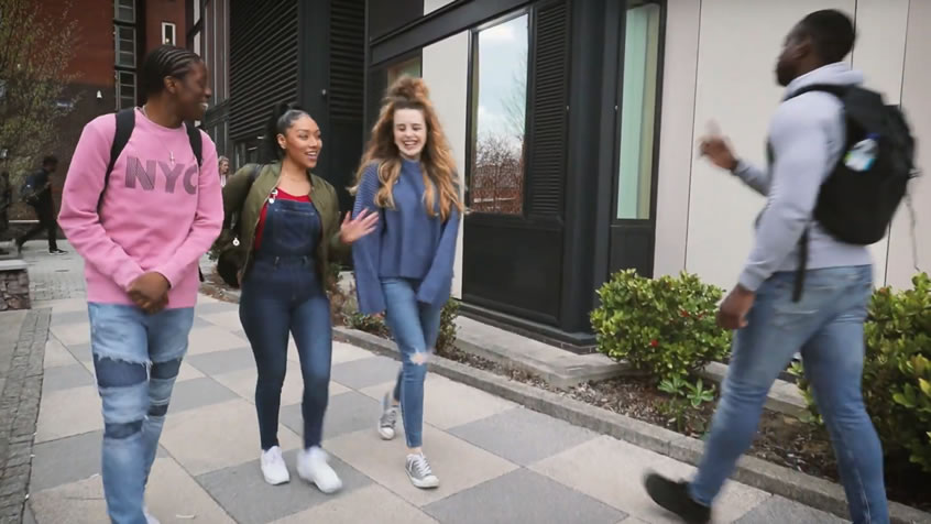 Group of students walking through Nixon Court