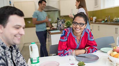 students chatting together in a shared kitchen