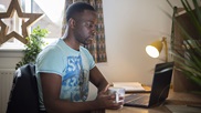 A student studying at his desk in student accommodation