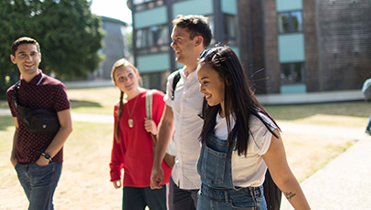 Students walking through green space outside accommodation